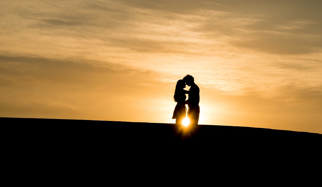 a couple hugging in sunset